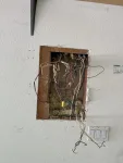 Before: open wall cavity with outdated wiring and splices — pre-upgrade condition