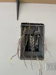 Rough-in: new load center set in wall, conductors pulled and ready for termination